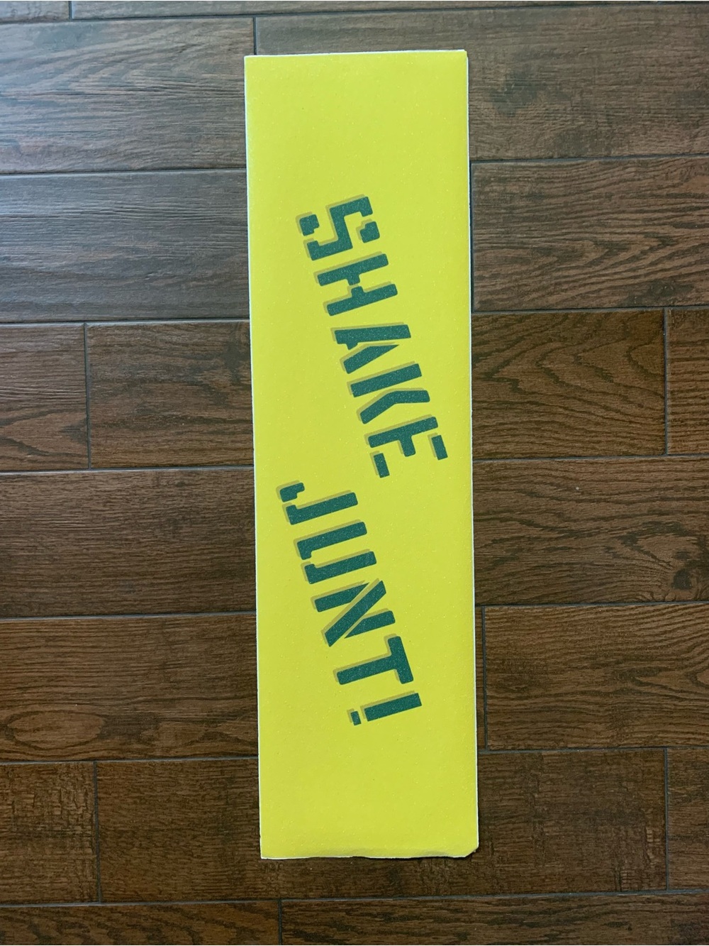 Bright Yellow Skateboard Grip with 'SHAKE JUNT!' Text